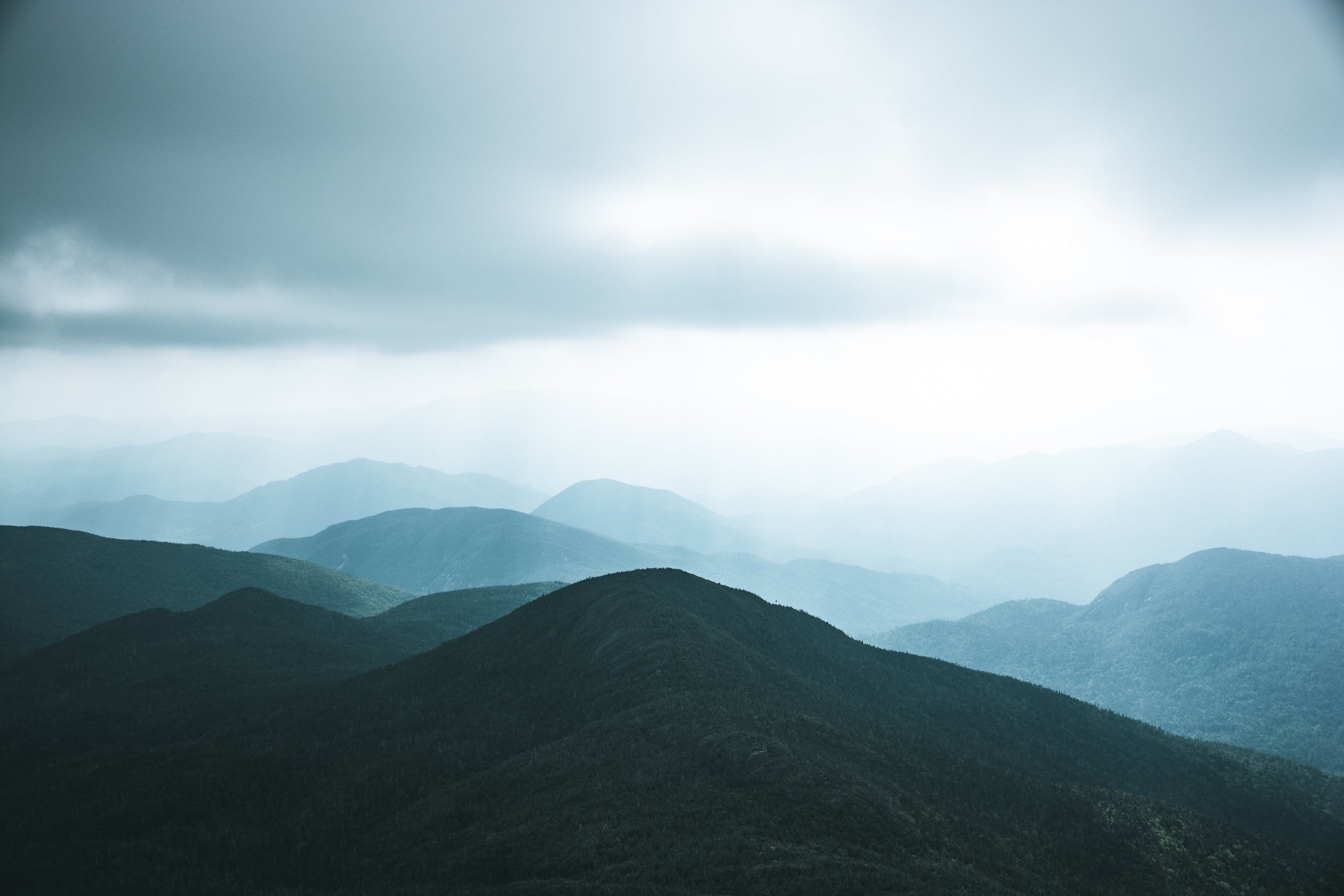 a-dark-green-hill-against-the-smoky-sky.jpg